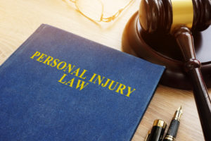 Atlanta Personal Injury Lawyer - Personal injury law on a desk and gavel.